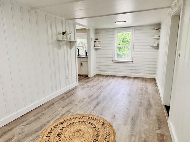 379 Main St, Mashpee, MA 02649 - unfurnished dining area with light wood finished floors, wooden walls, and baseboards