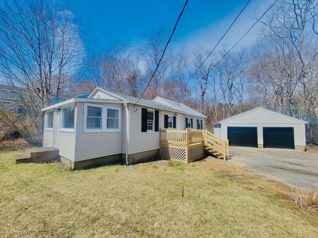 379 Main St, Mashpee, MA 02649 - manufactured / mobile home with an outdoor structure, a detached garage, and a front lawn