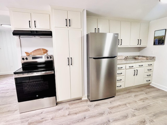 379 Main St, Mashpee, MA 02649 - kitchen with appliances with stainless steel finishes, under cabinet range hood, light wood-style floors, light stone countertops, and baseboards