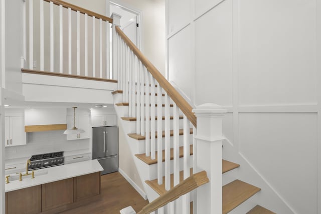 63 Ovington Dr, East Falmouth, MA 02536 - stairs with a decorative wall, a towering ceiling, and wood finished floors