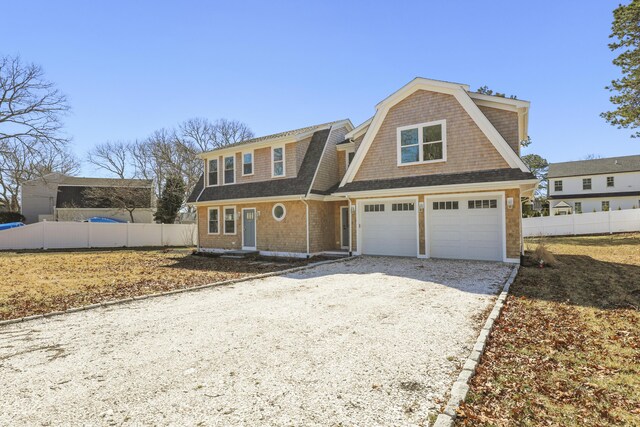 63 Ovington Dr, East Falmouth, MA 02536 - shingle-style home featuring gravel driveway, a gambrel roof, a garage, and fence