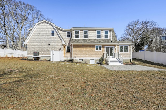 63 Ovington Dr, East Falmouth, MA 02536 - rear view of property featuring a fenced backyard, a gambrel roof, a shingled roof, and a lawn