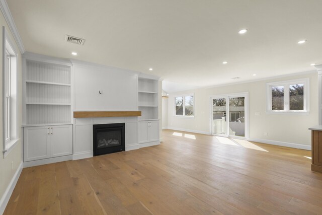 63 Ovington Dr, East Falmouth, MA 02536 - unfurnished living room featuring visible vents, baseboards, recessed lighting, light wood-style floors, and a glass covered fireplace