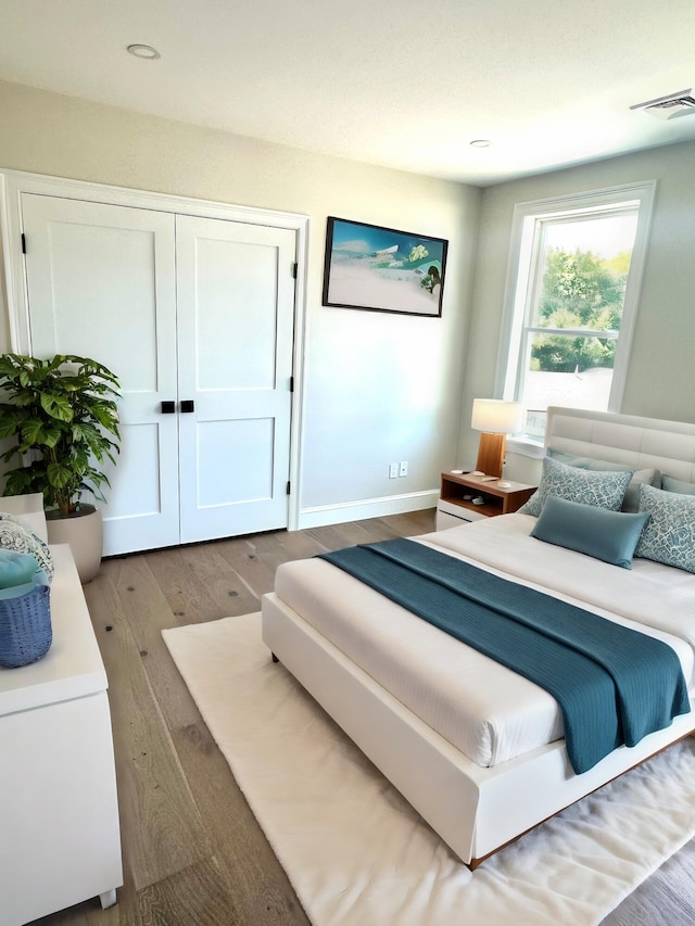 63 Ovington Dr, East Falmouth, MA 02536 - bedroom featuring a closet, visible vents, wood finished floors, and baseboards