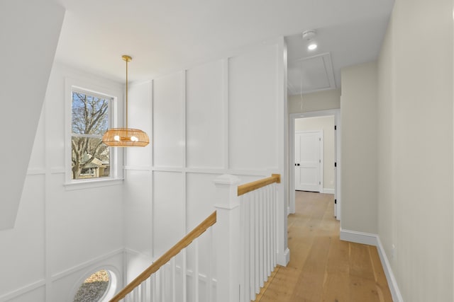 63 Ovington Dr, East Falmouth, MA 02536 - hall with an upstairs landing, attic access, light wood finished floors, a decorative wall, and baseboards