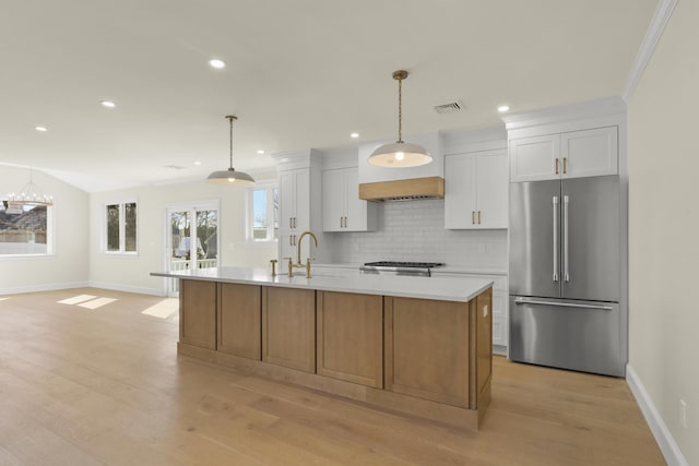63 Ovington Dr, East Falmouth, MA 02536 - kitchen with high quality fridge, light countertops, a sink, visible vents, and white cabinets