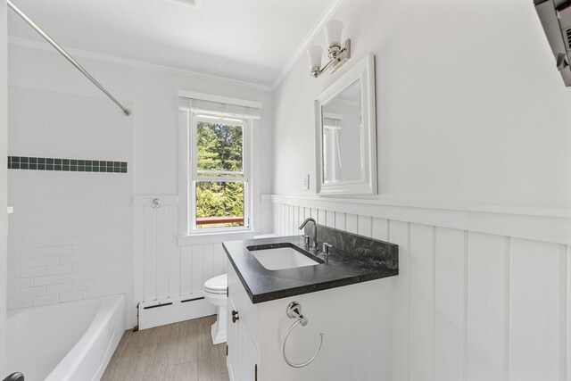 26 Hinckley Cir, Osterville, MA 02655 - bathroom with baseboard heating, a wainscoted wall, vanity, crown molding, and washtub / shower combination