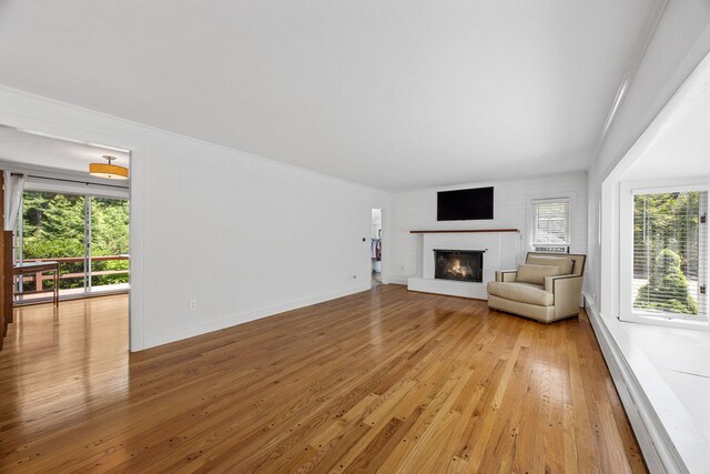 26 Hinckley Cir, Osterville, MA 02655 - living area with healthy amount of natural light, light wood-type flooring, and a brick fireplace