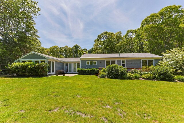 26 Hinckley Cir, Osterville, MA 02655 - rear view of house with a lawn and french doors