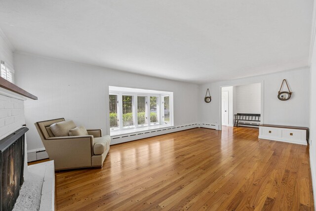 26 Hinckley Cir, Osterville, MA 02655 - living room with a fireplace, wood finished floors, and a baseboard radiator