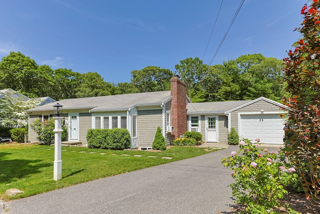 26 Hinckley Cir, Osterville, MA 02655 - single story home with a chimney, a front lawn, driveway, and a garage