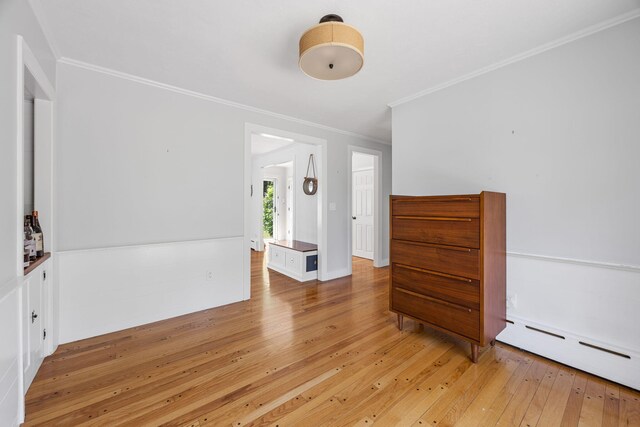 26 Hinckley Cir, Osterville, MA 02655 - empty room with ornamental molding, light wood-style floors, and a baseboard heating unit