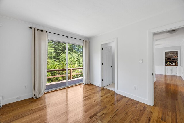 26 Hinckley Cir, Osterville, MA 02655 - unfurnished bedroom with wood-type flooring, crown molding, and access to outside
