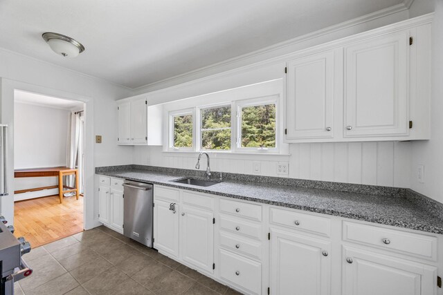 26 Hinckley Cir, Osterville, MA 02655 - kitchen with stainless steel dishwasher, white cabinetry, crown molding, dark tile patterned flooring, and range