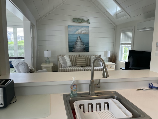 17 Hydrangea Ln, Mashpee, MA 02649 - kitchen with lofted ceiling, a wall mounted air conditioner, a sink, and wood walls