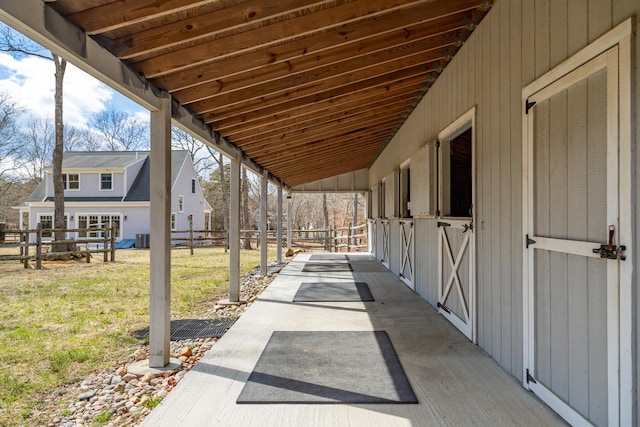 view of patio / terrace with central AC, an outbuilding, and an exterior structure