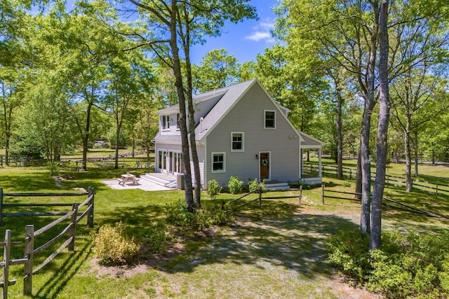 21 Cloverfield Way, Hatchville, MA 02536 - view of property exterior featuring a fire pit, a patio, and view of wooded area