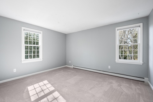 carpeted empty room featuring baseboards and baseboard heating