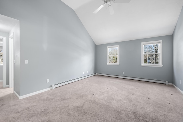 carpeted spare room featuring lofted ceiling, baseboards, a baseboard heating unit, and ceiling fan