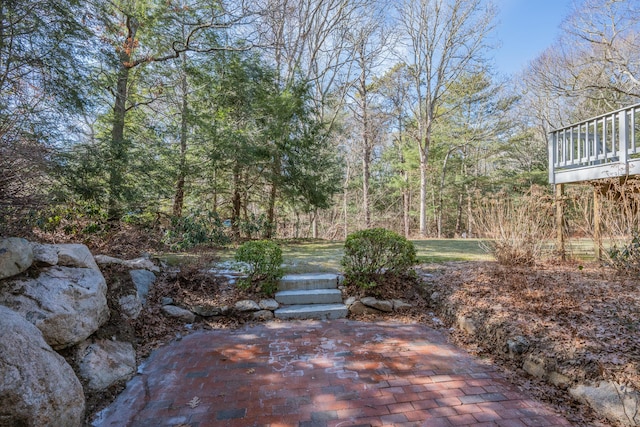 view of patio / terrace featuring a wooded view