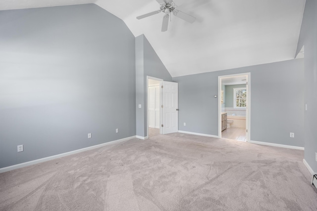 unfurnished bedroom with ceiling fan, high vaulted ceiling, carpet flooring, baseboards, and ensuite bath