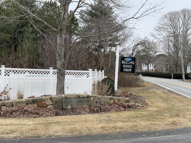 community sign featuring fence