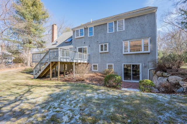 rear view of house with stairs, a chimney, a lawn, and a wooden deck