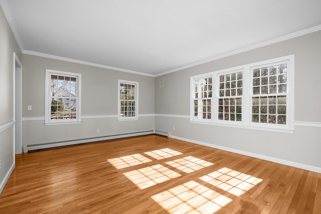 empty room with baseboards, ornamental molding, baseboard heating, and wood finished floors