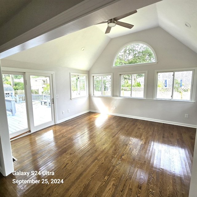 unfurnished living room featuring lofted ceiling, ceiling fan, baseboards, and dark wood finished floors