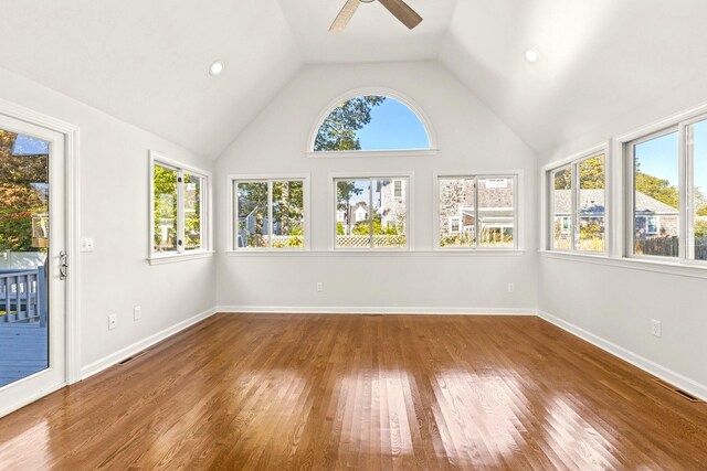 unfurnished sunroom with ceiling fan, plenty of natural light, visible vents, and vaulted ceiling