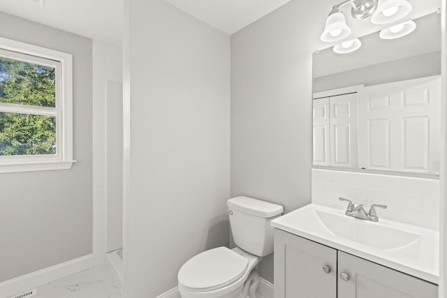 full bathroom featuring marble finish floor, toilet, vanity, baseboards, and walk in shower