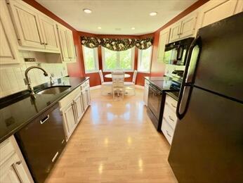 92 Cliffside Dr Unit 92, Cedarville, MA 02360 - kitchen featuring black appliances, dark countertops, recessed lighting, tasteful backsplash, and light wood-style flooring