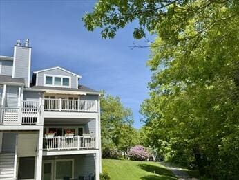 92 Cliffside Dr Unit 92, Cedarville, MA 02360 - rear view of property featuring a balcony, a yard, and a chimney