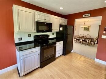 92 Cliffside Dr Unit 92, Cedarville, MA 02360 - kitchen featuring black appliances, dark countertops, light wood-style floors, white cabinets, and recessed lighting