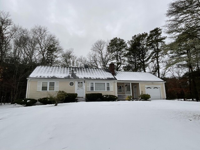 95 Anchor Ln, Cotuit, MA 02635 - view of front of home featuring a garage, a chimney, and a porch