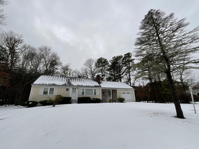 95 Anchor Ln, Cotuit, MA 02635 - view of front of house featuring an attached garage, a chimney, and metal roof