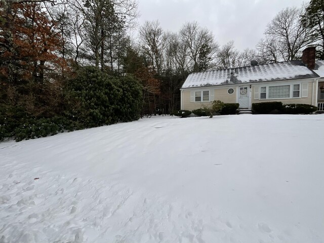 95 Anchor Ln, Cotuit, MA 02635 - snow covered property with a chimney and entry steps