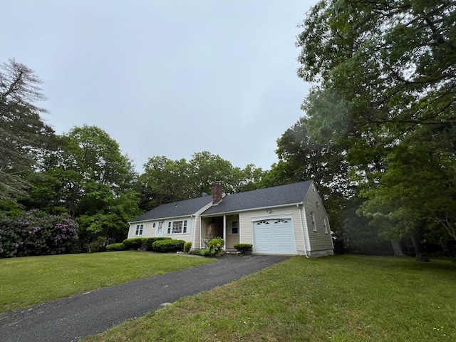 95 Anchor Ln, Cotuit, MA 02635 - view of front facade with a garage, asphalt driveway, a chimney, and a front lawn