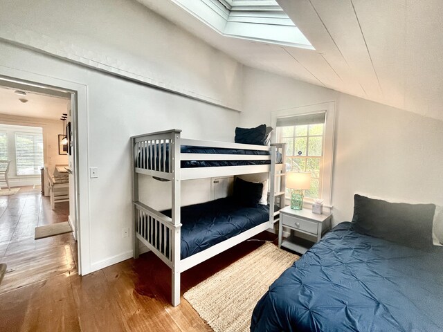 25 Milestone Way, Mashpee, MA 02649 - bedroom with wood finished floors, lofted ceiling, multiple windows, a skylight, and baseboards