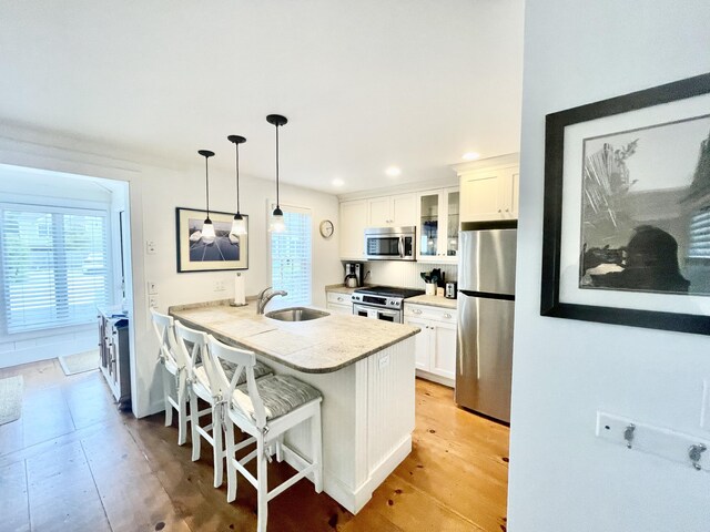 25 Milestone Way, Mashpee, MA 02649 - kitchen with stainless steel appliances, a sink, white cabinetry, glass insert cabinets, and recessed lighting