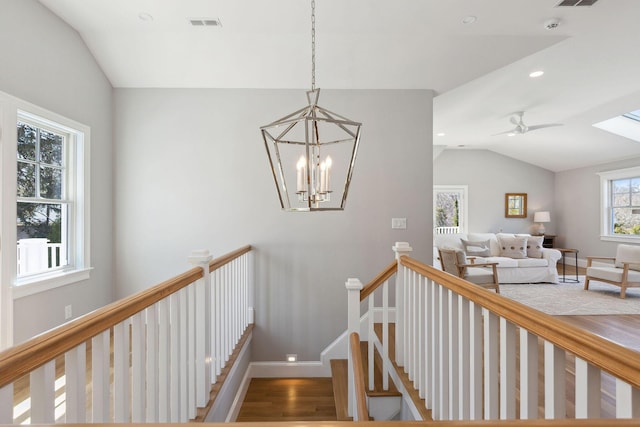 44 Tonset Rd, Orleans, MA 02653 - stairway with visible vents, baseboards, wood finished floors, ceiling fan with notable chandelier, and lofted ceiling
