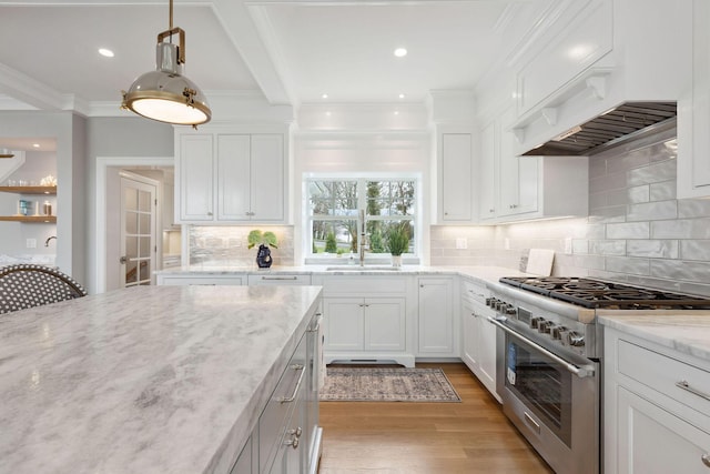 44 Tonset Rd, Orleans, MA 02653 - kitchen with crown molding, white cabinets, high end range, and light wood-style floors