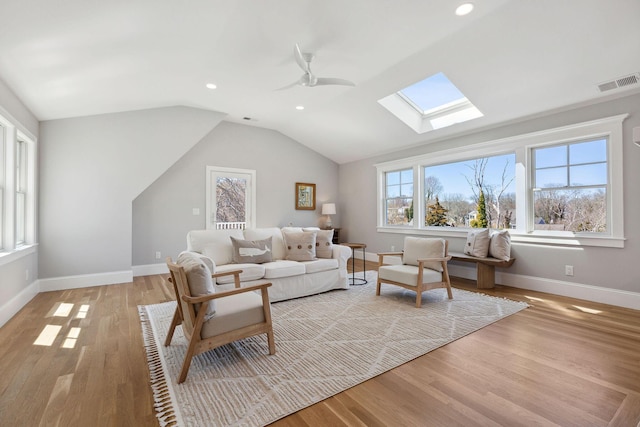 44 Tonset Rd, Orleans, MA 02653 - living area with visible vents, baseboards, light wood-style flooring, and lofted ceiling with skylight