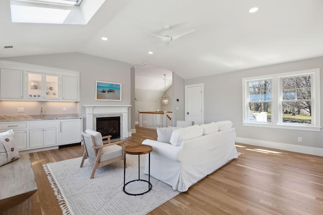 44 Tonset Rd, Orleans, MA 02653 - living room with baseboards, light wood finished floors, vaulted ceiling, and indoor wet bar