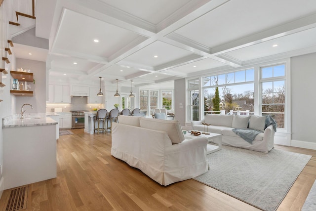 44 Tonset Rd, Orleans, MA 02653 - living room with light wood finished floors, visible vents, beamed ceiling, and coffered ceiling