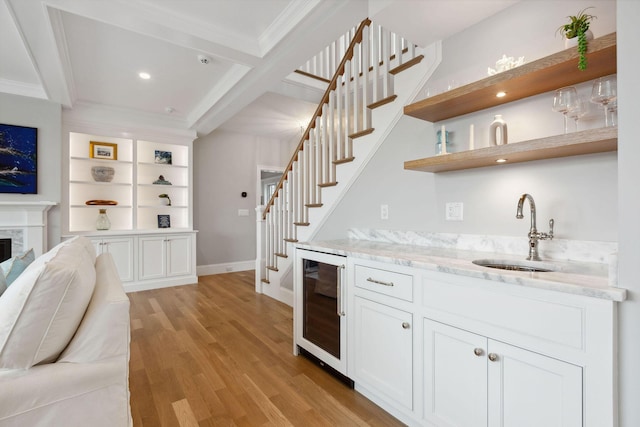 44 Tonset Rd, Orleans, MA 02653 - bar with wet bar, stairway, wine cooler, light wood finished floors, and a sink