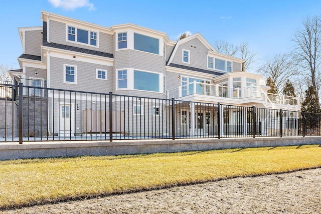 back of property featuring fence and a yard