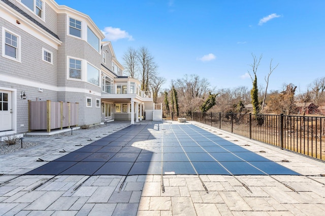 view of swimming pool featuring a fenced in pool, a patio area, and fence