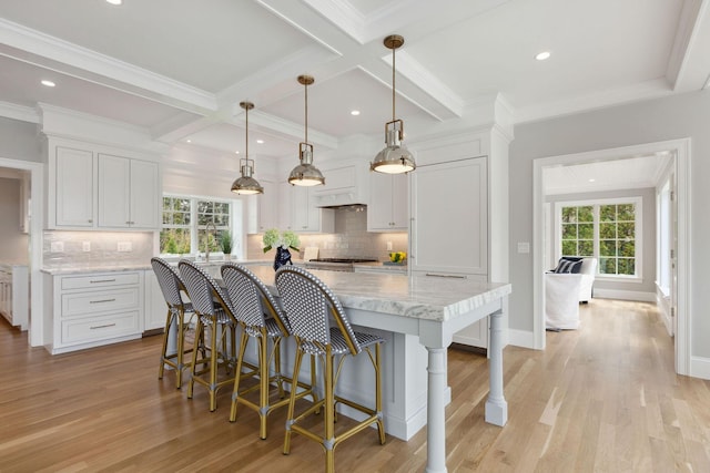 44 Tonset Rd, Orleans, MA 02653 - kitchen with white cabinets, light wood-style floors, and a breakfast bar area
