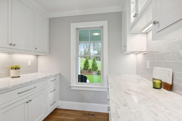44 Tonset Rd, Orleans, MA 02653 - kitchen featuring visible vents, baseboards, ornamental molding, dark wood-style floors, and decorative backsplash